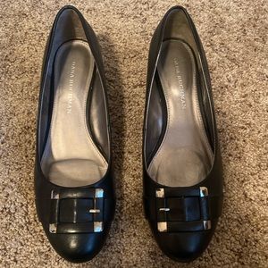 Black slip-on shoes with silver buckles